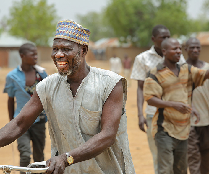 Man smiling with a bicycle